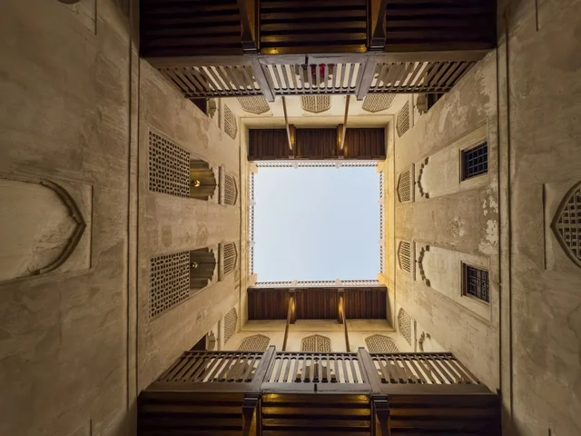 Symmetrical interior view of Jabreen Fort in Oman showcasing traditional Omani architecture and wooden balconies around the courtyard. bahla.Oman - February 15 2026 .