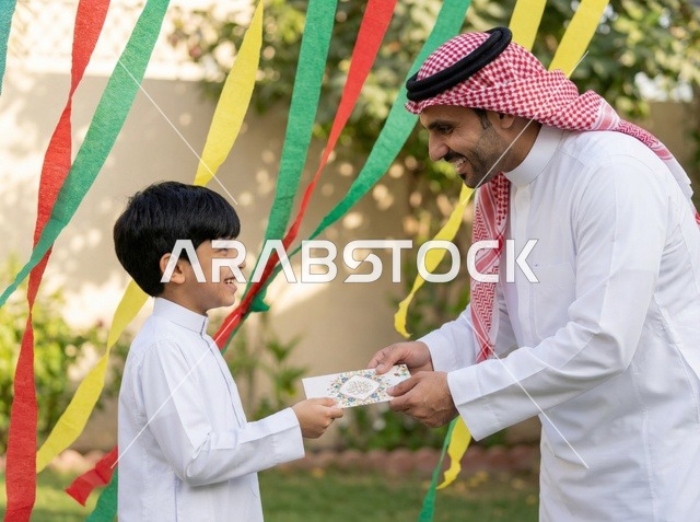 Saudi Man Giving Eid Gift Envelope to Boy Outdoors