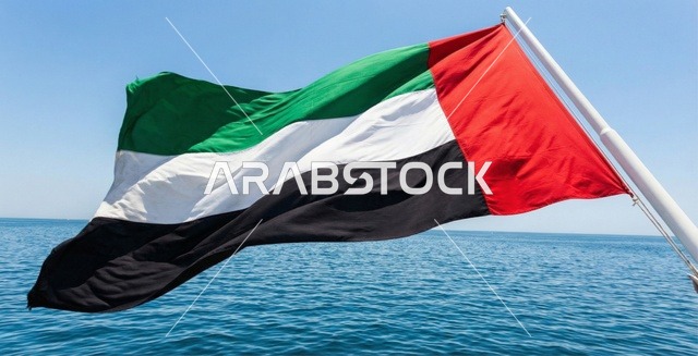 UAE Flag Waving Over Blue Sea Water