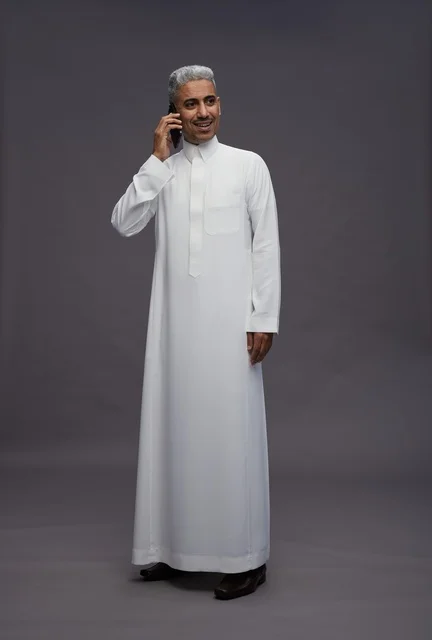 Saudi Man in Thobe Talking on Mobile Phone Studio Shot