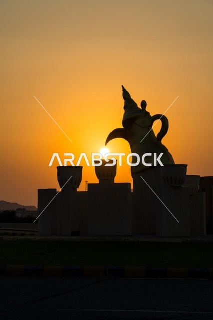 منظر غروب الشمس عند دوار الدله العربيه  مع فناجين القهوه في قرية مدركه على طريق جده في مكه المكرمه, منطقه شعبيه تاريخيه قديمه, التضاريس الجبليه والطرق المعبده  في المدينه, المملكه العربيه السعوديه