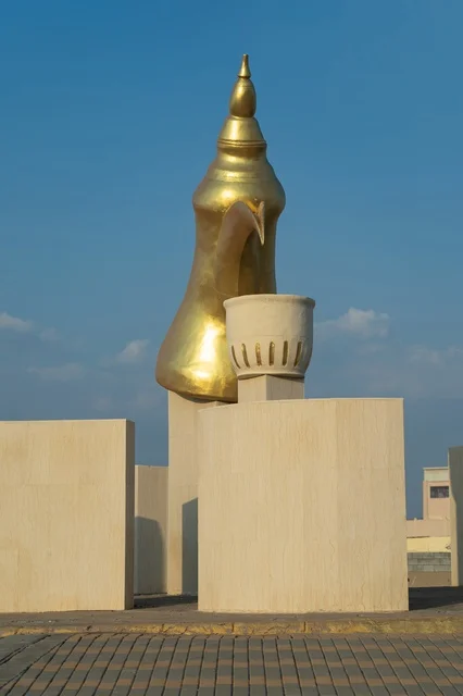 The Arabic coffee pot roundabout with coffee cups in the village of Mudrikah on the Jeddah road in Mecca, a historic popular area, with mountainous terrain and paved roads in the city, Kingdom of Saudi Arabia.