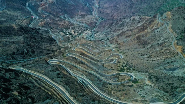 The mountainous terrain in Al-Hada, south of Saudi Arabia, the winding paved roads in the city of Abha, the nature of the rugged rocky mountains, the background of nature.