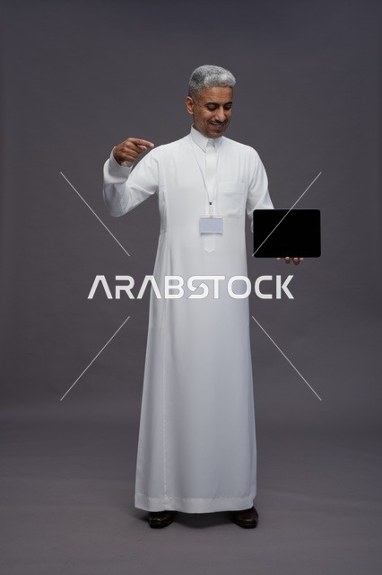 Saudi professional holding blank tablet screen