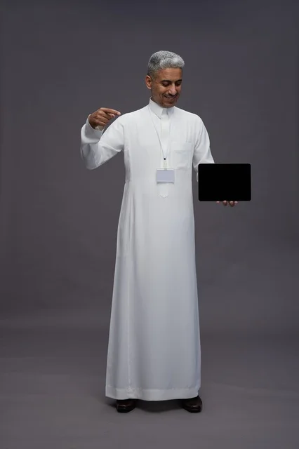 Saudi professional holding blank tablet screen