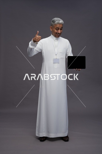 Saudi professional holding blank tablet screen