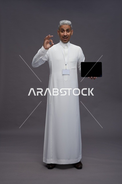 Saudi professional holding blank tablet screen