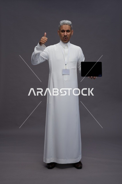 Saudi professional holding blank tablet screen