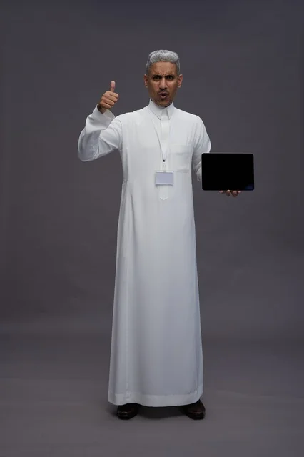 Saudi professional holding blank tablet screen