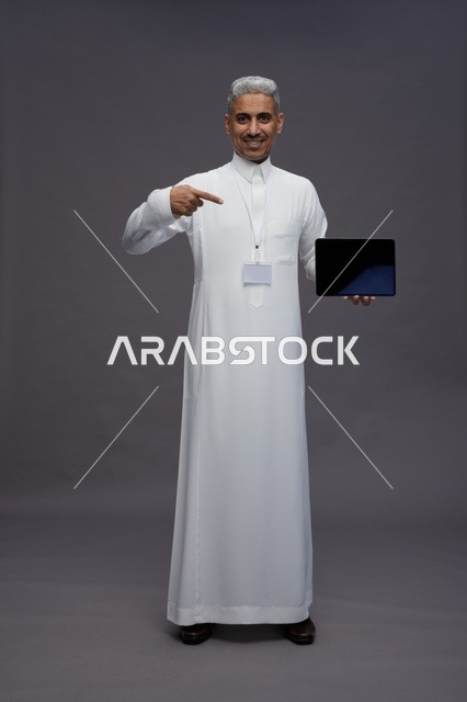 Saudi professional holding blank tablet screen