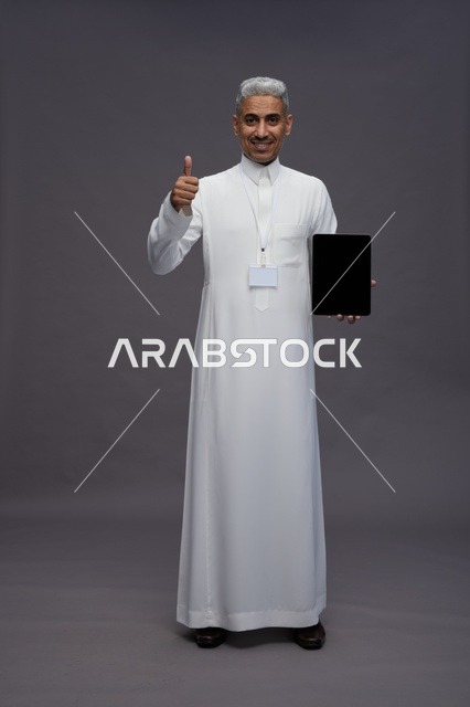 Saudi professional holding blank tablet screen