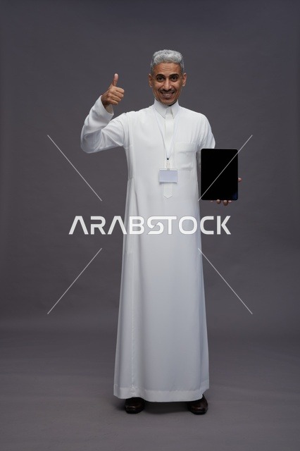 Saudi professional holding blank tablet screen