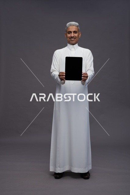 Saudi professional holding blank tablet screen