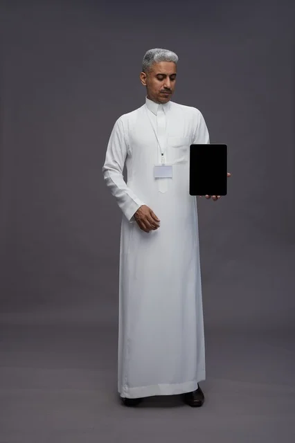 Saudi professional holding blank tablet screen