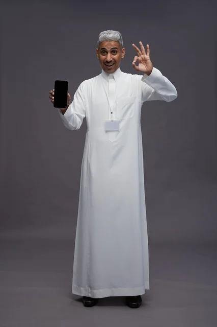 رجل سعودي يعرض شاشة هاتف ذكي فارغة