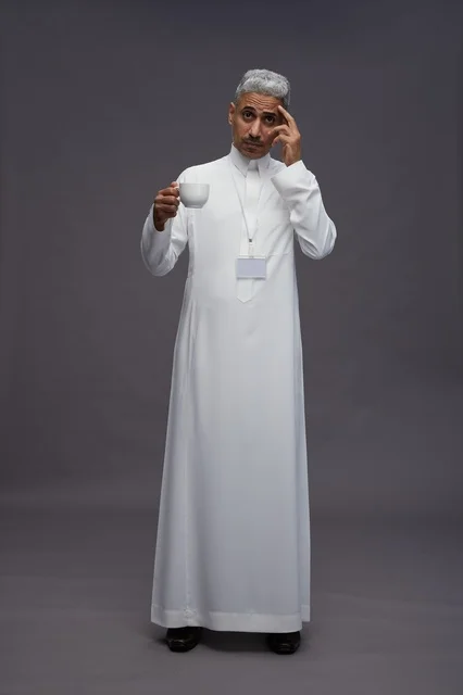 A portrait of an Arab Saudi Gulf man wearing a white thobe and enjoying drinking coffee, with a gray background, full body. A portrait of an Arab Saudi Gulf man wearing a white thobe and enjoying drinking coffee, with a gray background, full body.