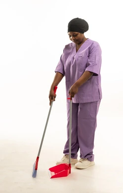 Female African Cleaner in Purple Scrubs with Broom