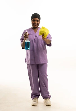 عاملة نظافة بزي أرجواني مع أدوات تعقيم