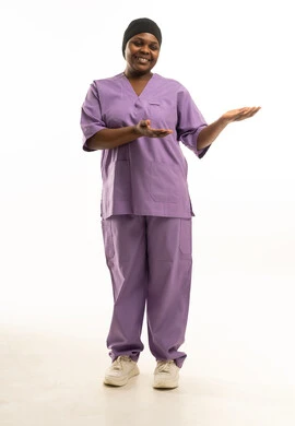 ممرضة سمراء بزي طبي بنفسجي تشير للجانب