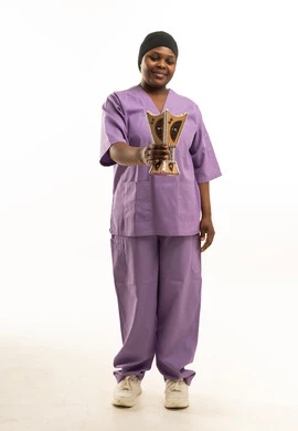 African Nurse in Purple Scrubs Holding Mabkhara