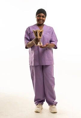African Nurse in Purple Scrubs Holding Arabic Incense Burner