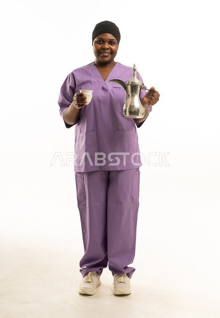 African Woman in Scrubs Holding Arabic Coffee Pot