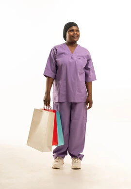 Saudi African Nurse Holding Shopping Bags in Scrubs