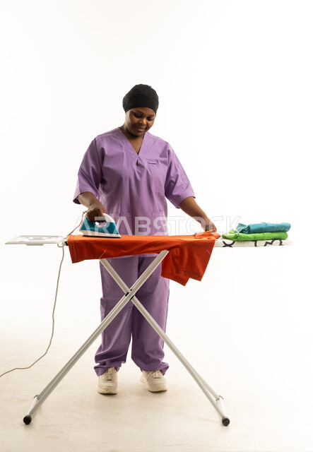 Saudi Domestic Worker Ironing Clothes on White Background