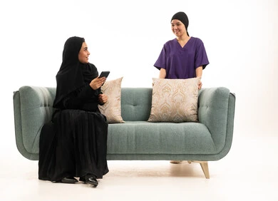 Saudi Woman and Domestic Worker on Studio Sofa