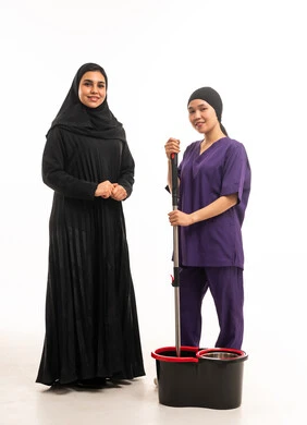 امرأة سعودية مع عاملة منزلية وأدوات تنظيف