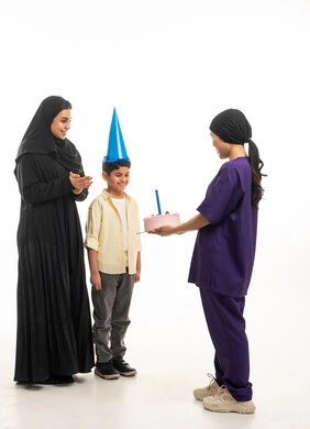 Saudi Woman and Son Celebrating Birthday with Domestic Worker