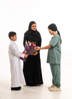 Saudi Boy and Woman Giving Flowers to Domestic Worker