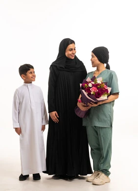 Saudi Family and Domestic Worker with Flowers in Studio