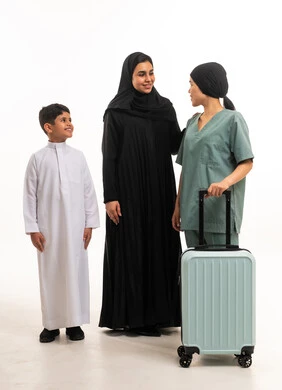 عائلة سعودية وعاملة منزلية مع حقيبة سفر استوديو