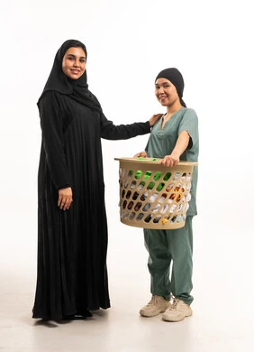 Saudi Woman with Asian Domestic Worker and Laundry