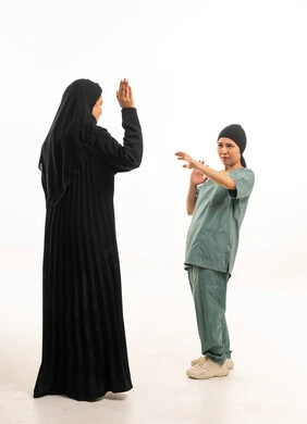 Saudi Woman and Domestic Worker in White Studio