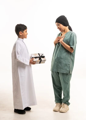 Saudi Boy Giving Gift to Domestic Worker on White