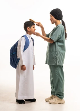 Domestic Worker Grooming Saudi Boy for School