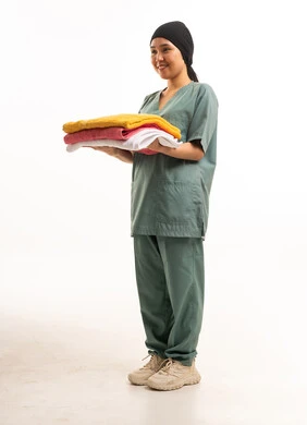 East Asian Domestic Worker in Scrubs Holding Towels