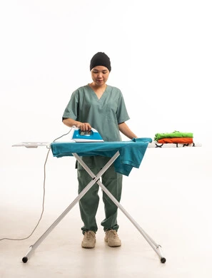 Southeast Asian Housemaid Ironing Clothes on White Background