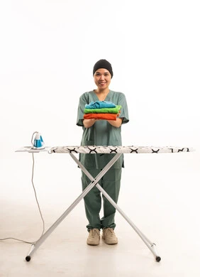 Asian Domestic Worker with Ironing Board and Laundry