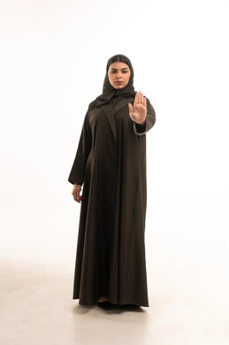 Arab Woman in Abaya Making Stop Gesture on White Background