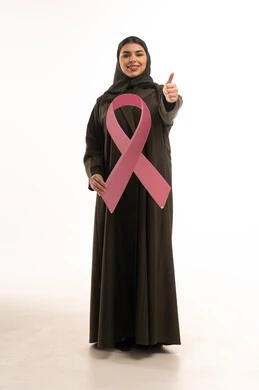 امرأة سعودية مع شعار التوعية بسرطان الثدي الوردي