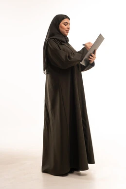 Saudi Woman in Black Abaya Writing on Clipboard