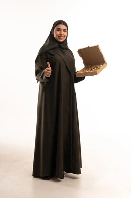 Saudi Woman in Abaya Holding Donuts with Thumbs Up