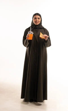 Saudi Woman in Black Abaya Holding Juice and Sandwich
