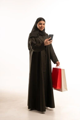 Saudi Woman with Shopping Bags and Smartphone
