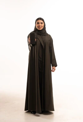 Saudi Woman in Abaya Holding Smartphone White Background