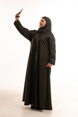 Saudi Woman in Black Abaya Taking Selfie on White Background