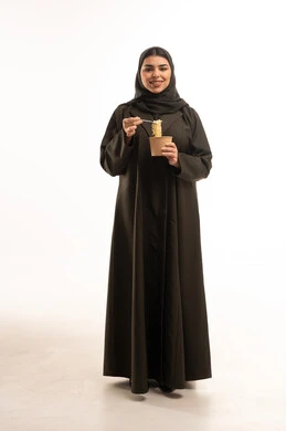 Saudi Woman in Black Abaya Holding Noodles Cup